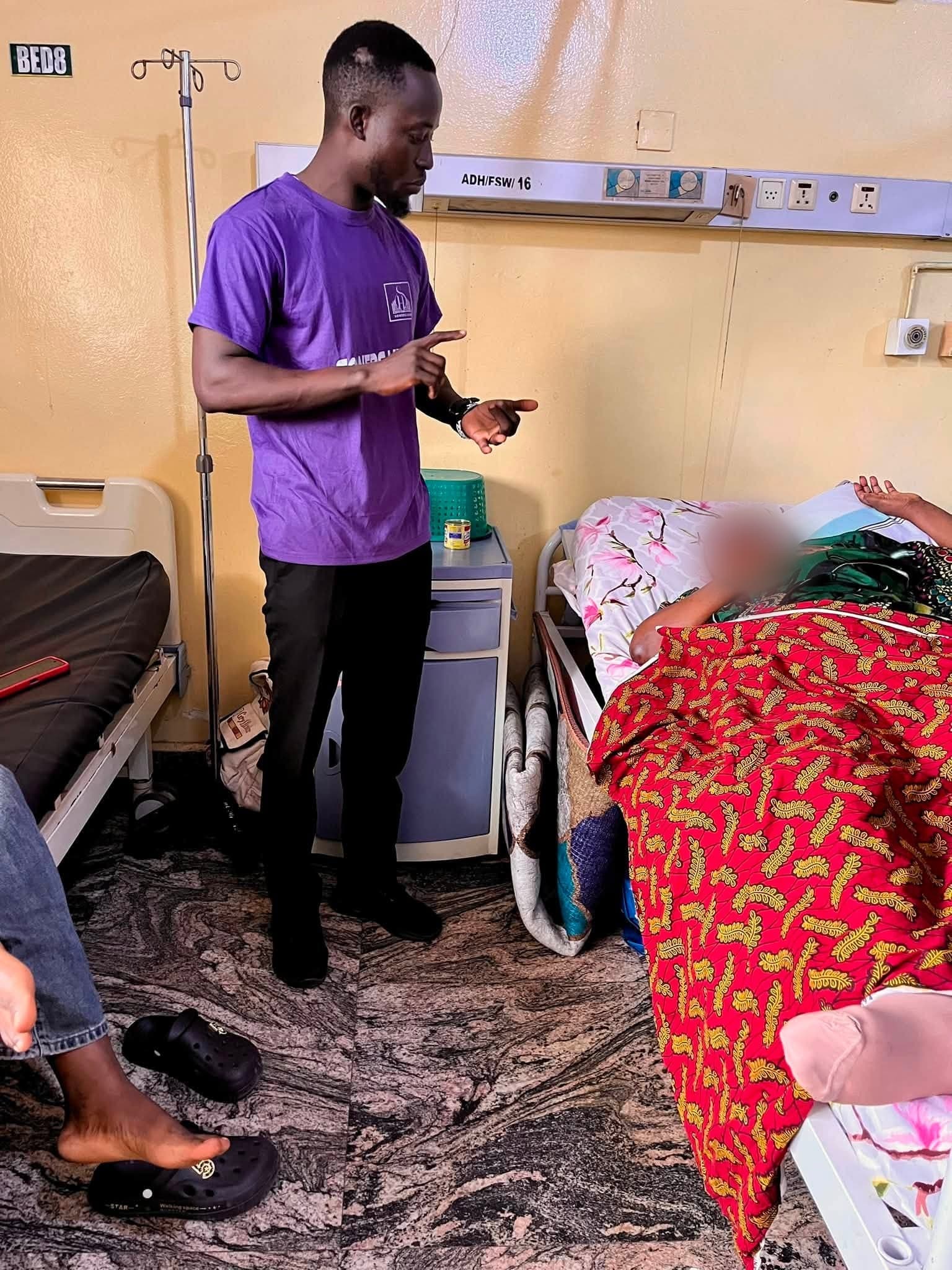 A SowersHub volunteer praying with a patient on a hospital ward
